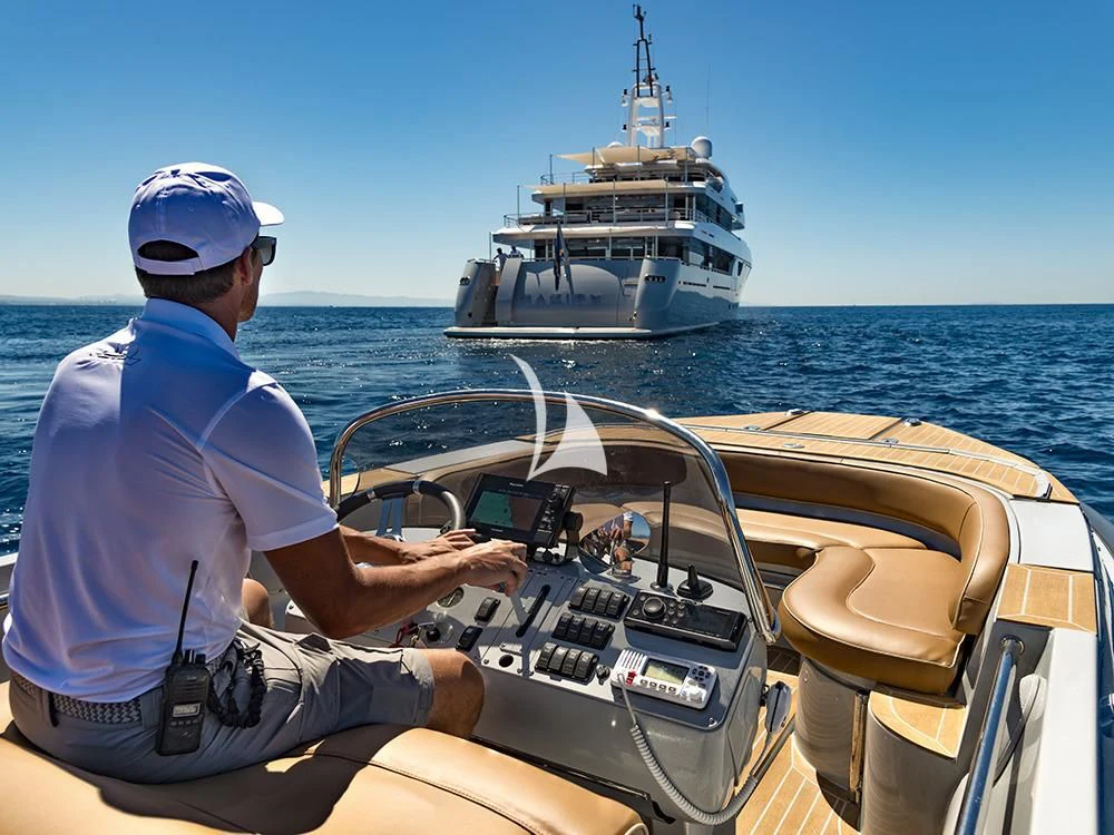 a person driving a boat aboard TALEYA Yacht for Sale