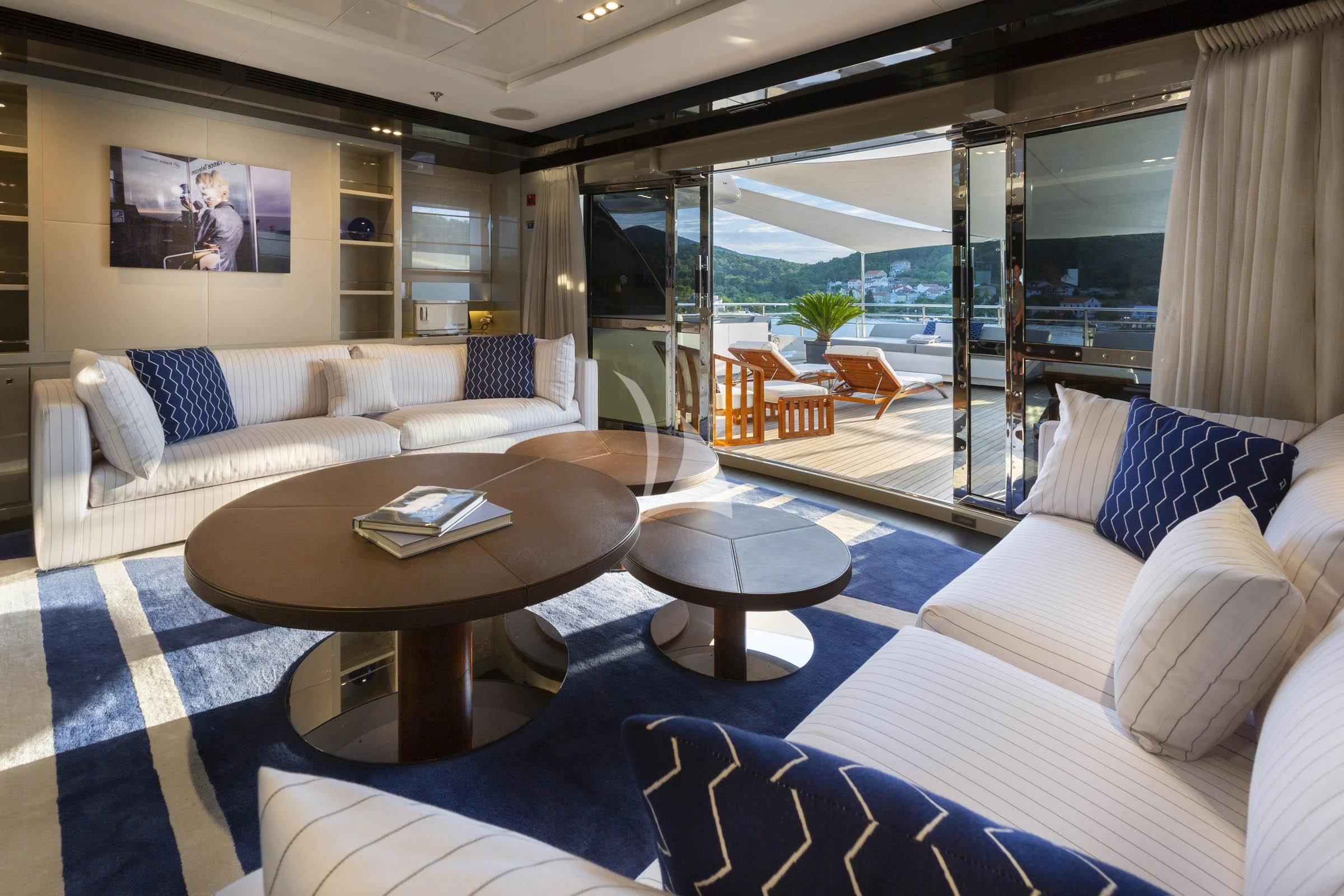 a living room with a large glass door aboard TALEYA Yacht for Sale