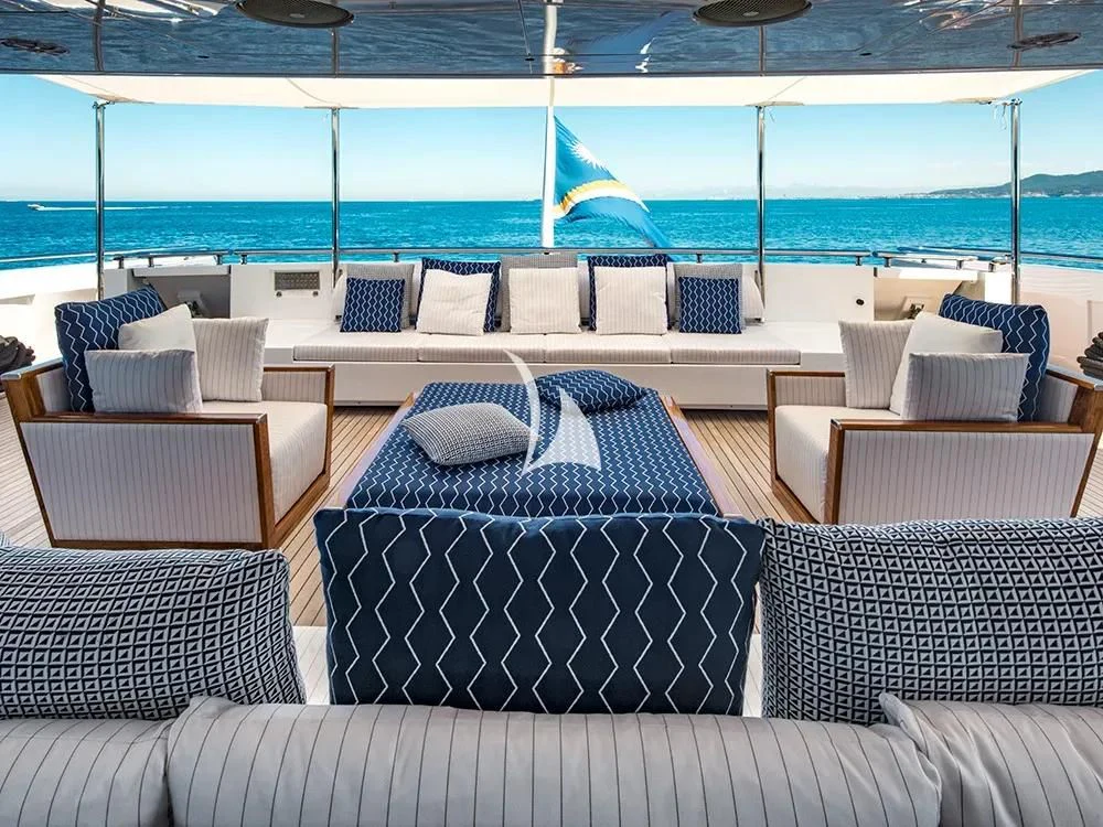 a couch and chairs on a deck aboard TALEYA Yacht for Sale