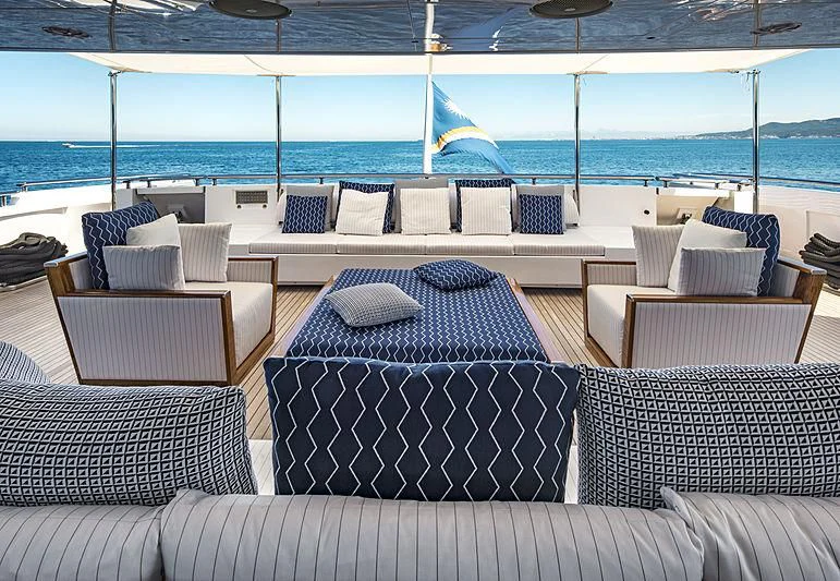 a couch and chairs on a boat aboard TALEYA Yacht for Sale