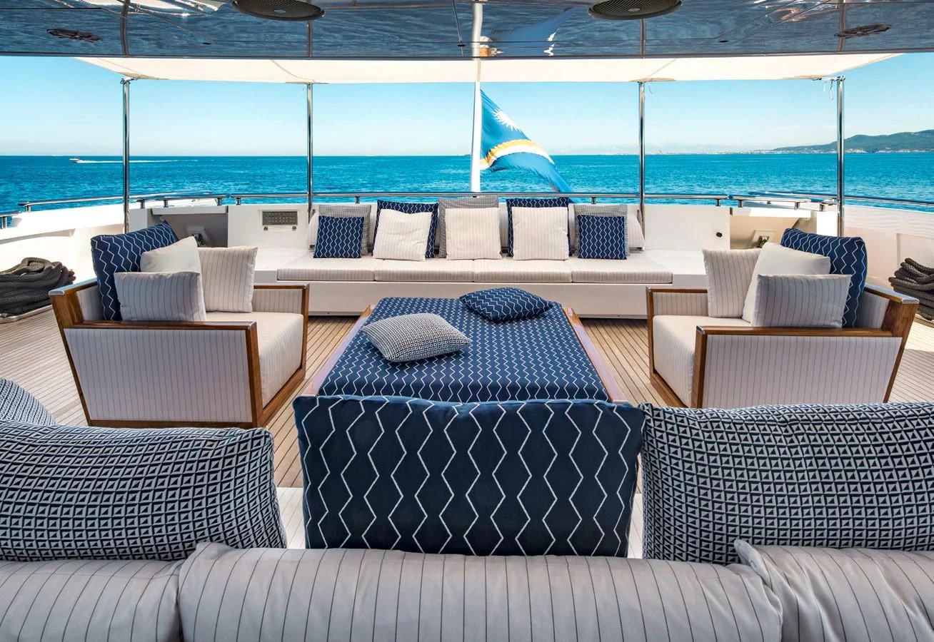 a couch and chairs on a deck aboard TALEYA Yacht for Sale