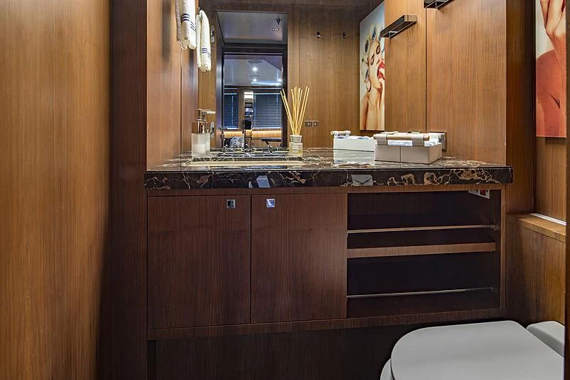 a bathroom with a sink and a mirror aboard TALEYA Yacht for Sale