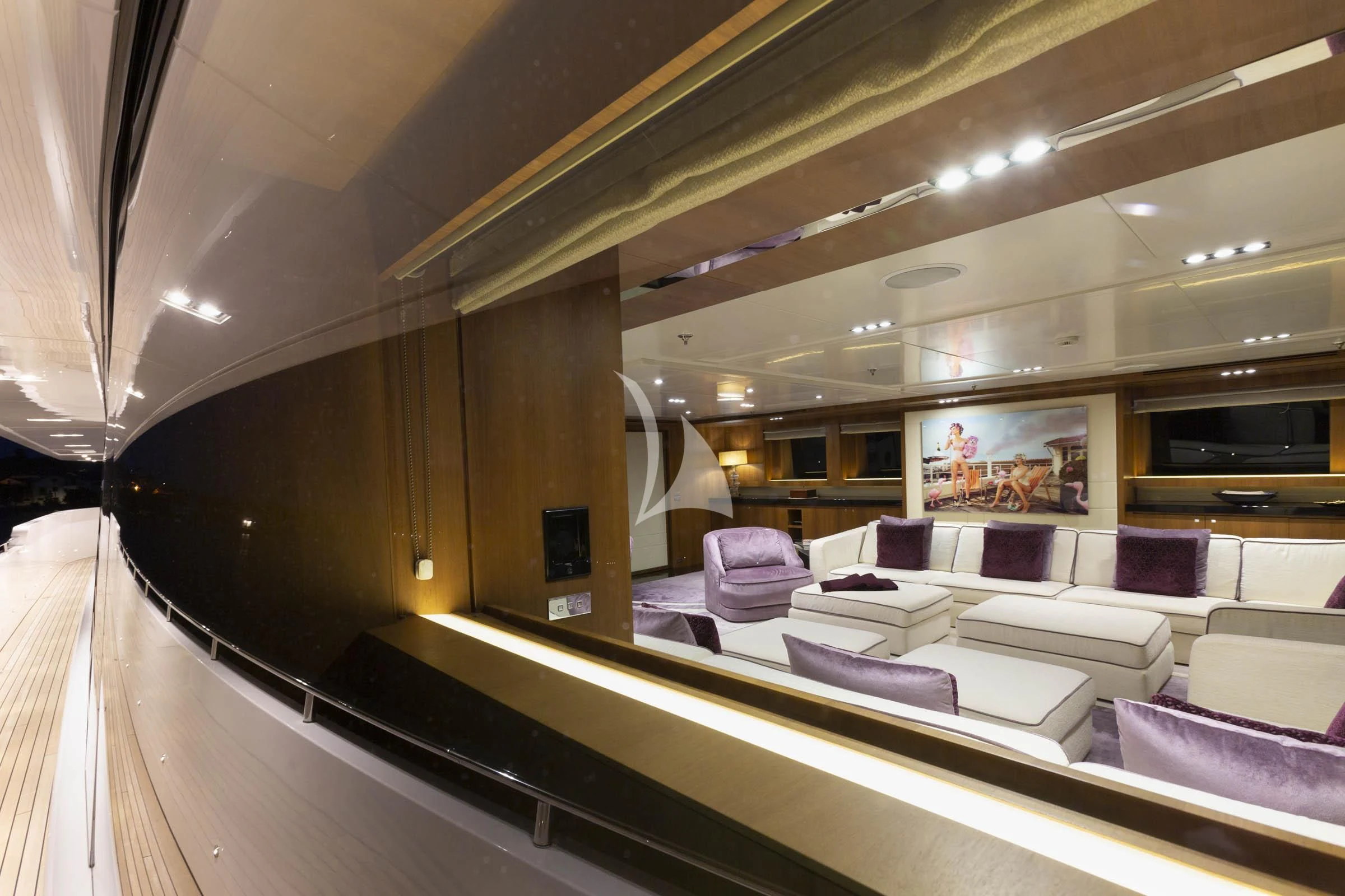 inside of a building with a large window and a large couch aboard TALEYA Yacht for Sale