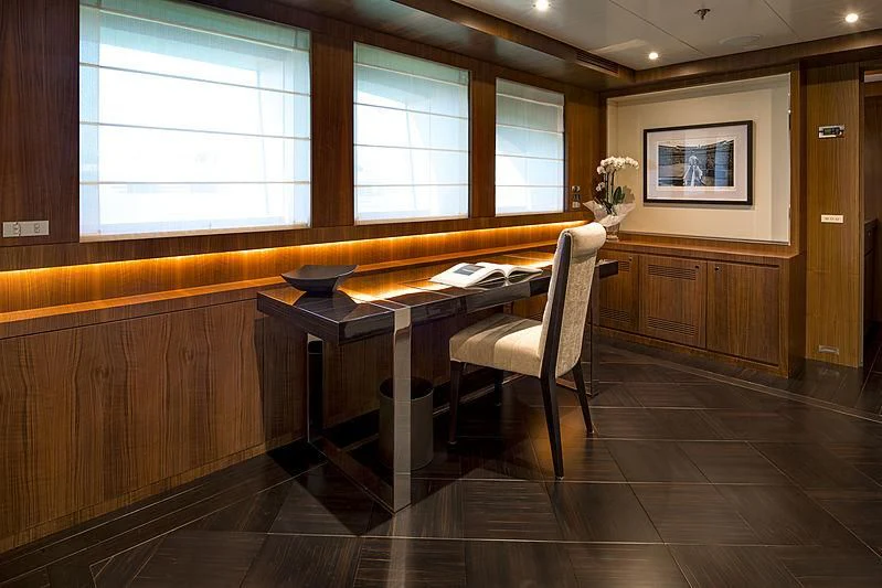 a room with a desk and a chair aboard TALEYA Yacht for Sale
