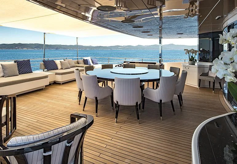a room with a table and chairs aboard TALEYA Yacht for Sale