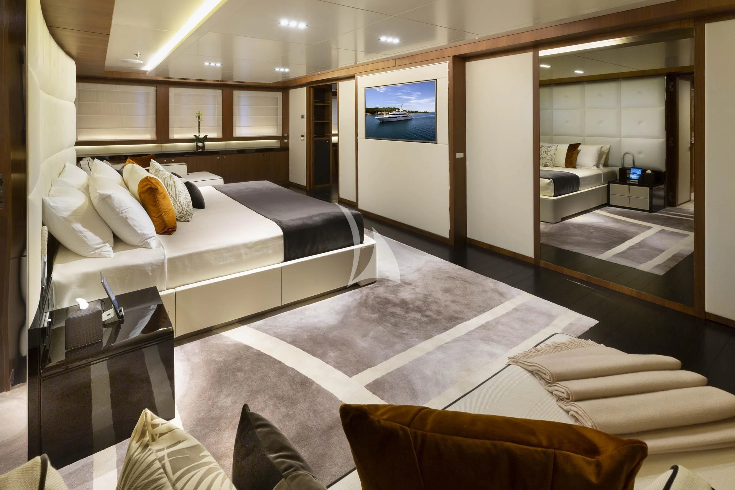 a room with a bed and a mirror aboard TALEYA Yacht for Sale