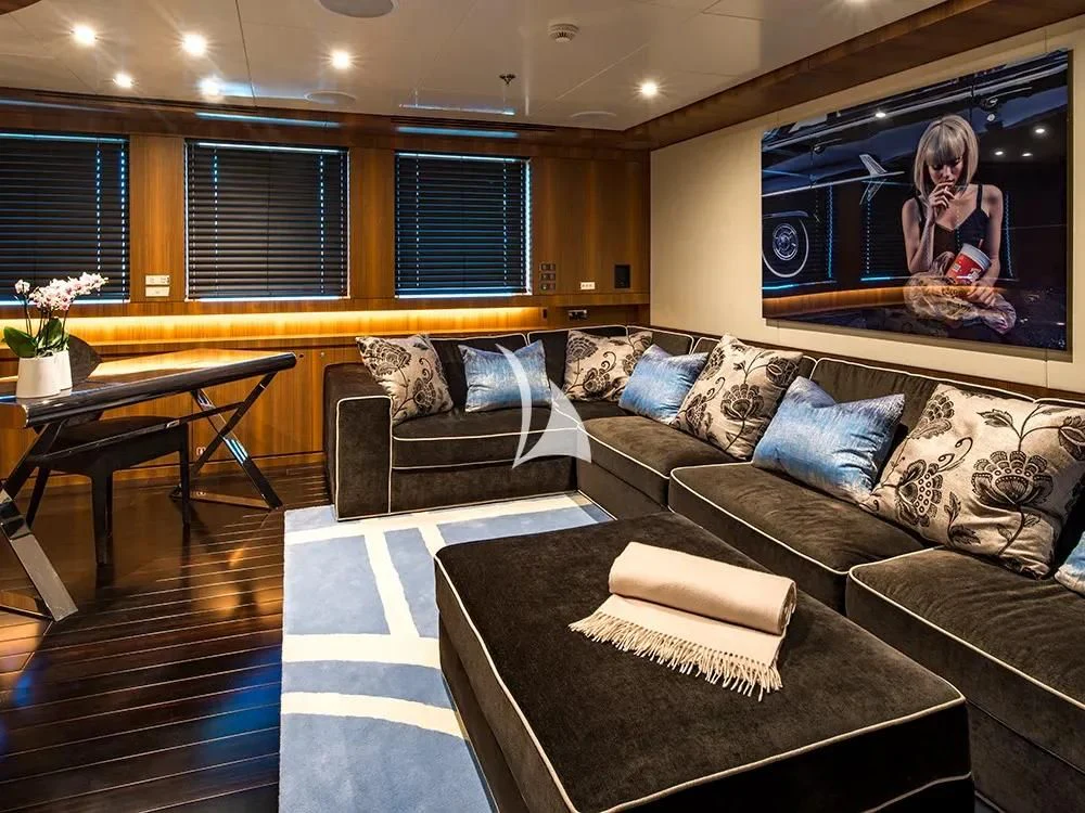 a living room with a couch and a tv aboard TALEYA Yacht for Sale
