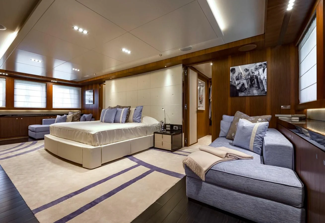 a large room with a bed and a couch aboard TALEYA Yacht for Sale