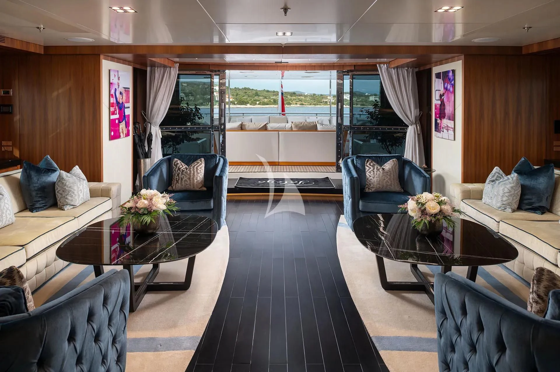 a living room with a large window aboard TALEYA Yacht for Sale