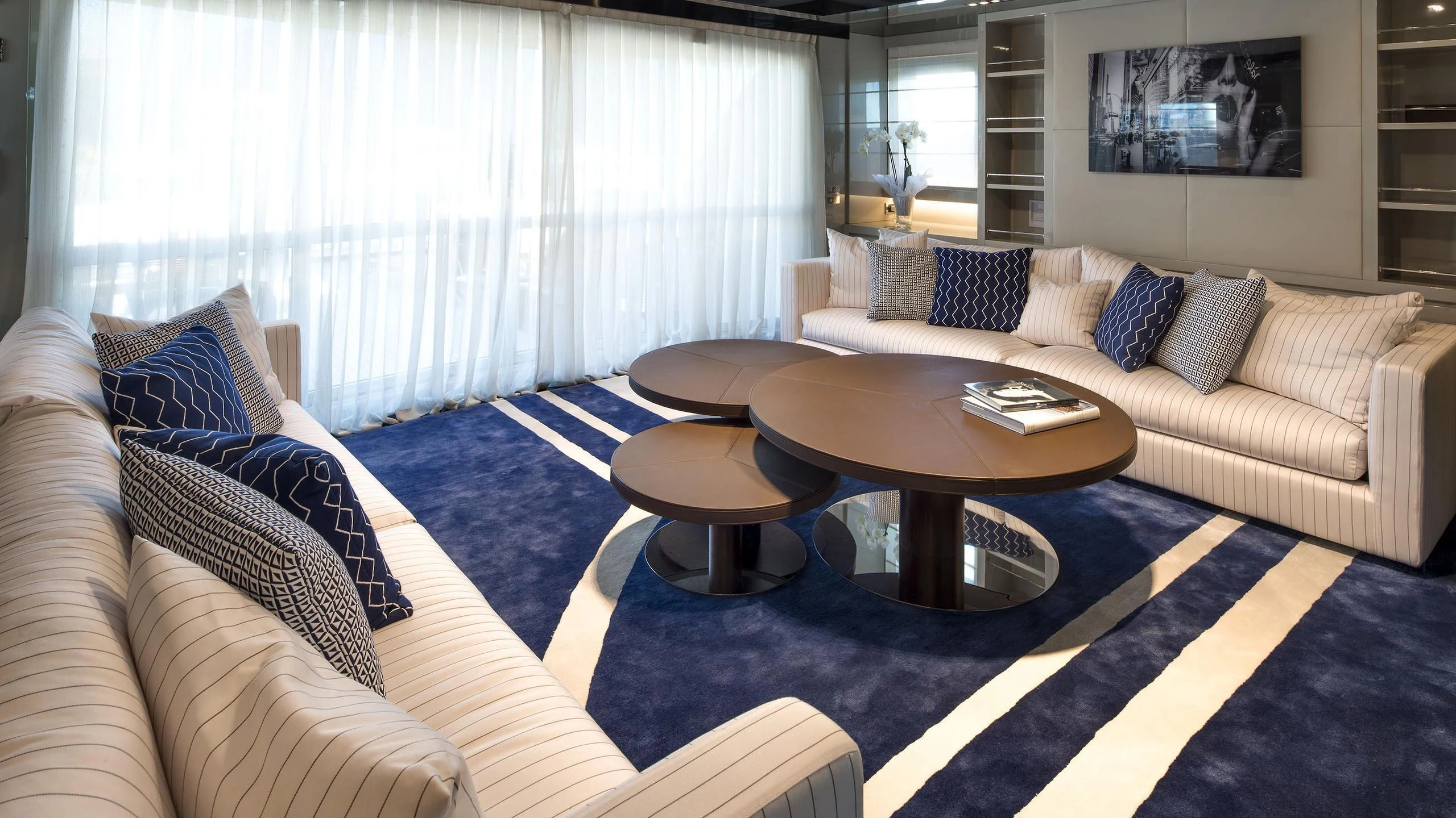 a living room with a couch and coffee table aboard TALEYA Yacht for Sale