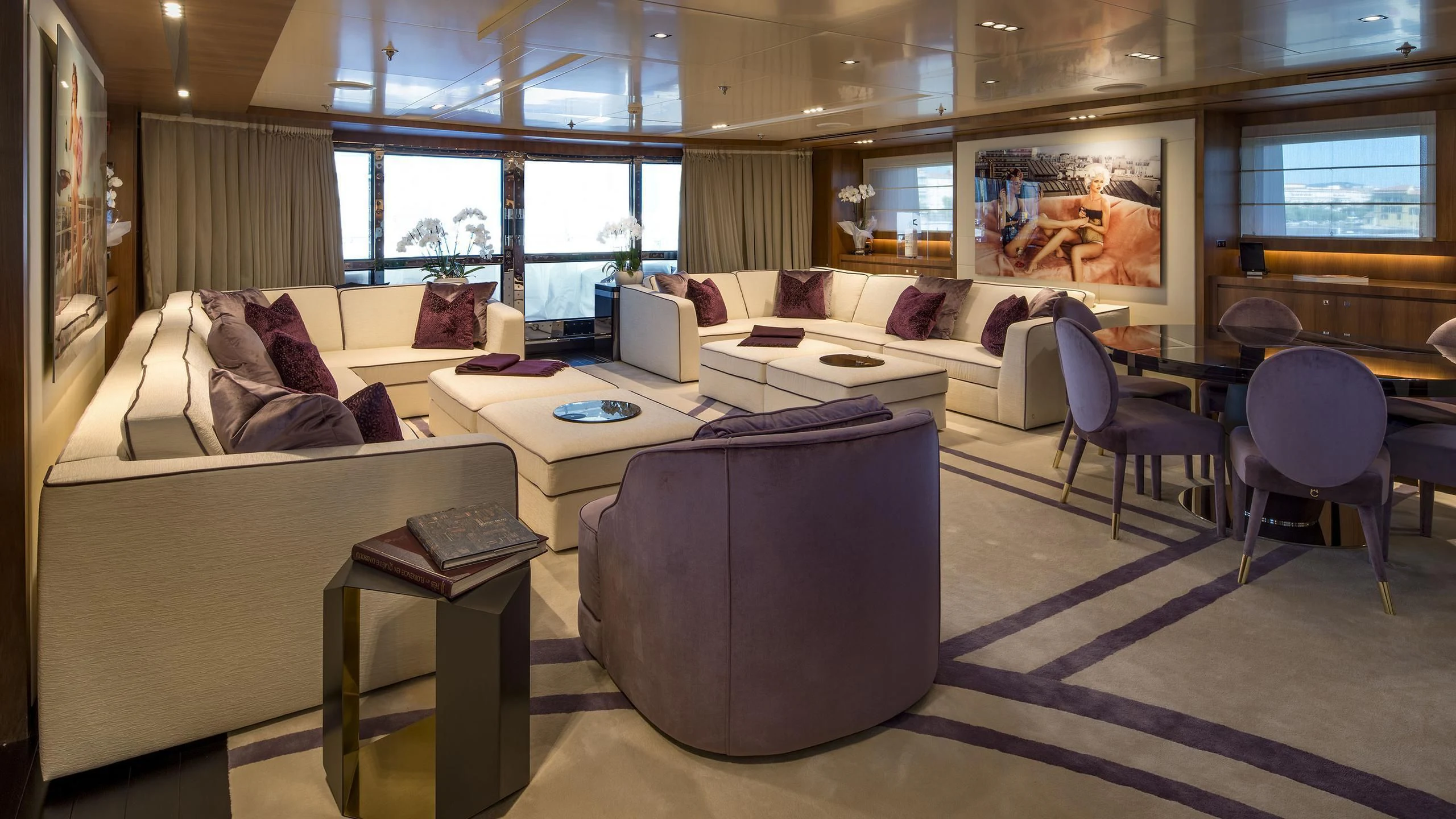 a living room with a couch and a table aboard TALEYA Yacht for Sale