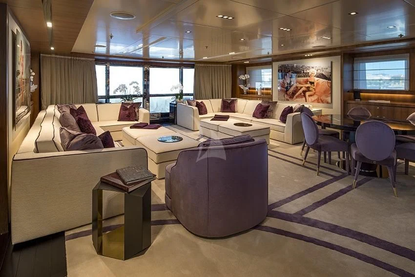 a living room with a couch and a table aboard TALEYA Yacht for Sale