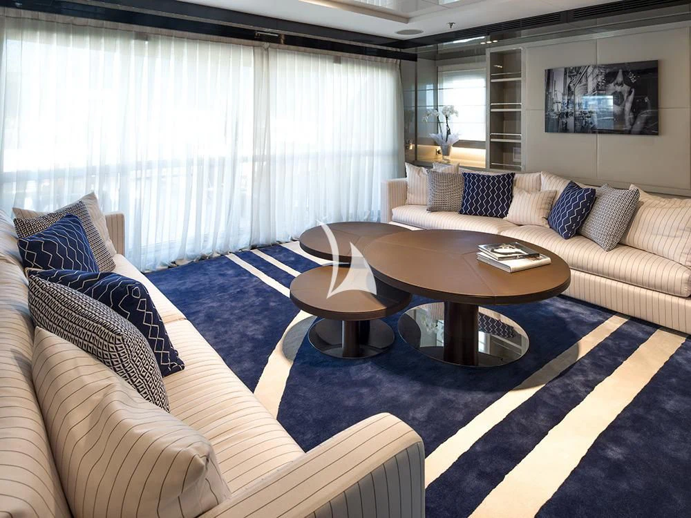 a living room with a couch and coffee table aboard TALEYA Yacht for Sale