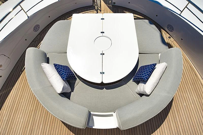 a white round table with a white round tablecloth on it aboard TALEYA Yacht for Sale