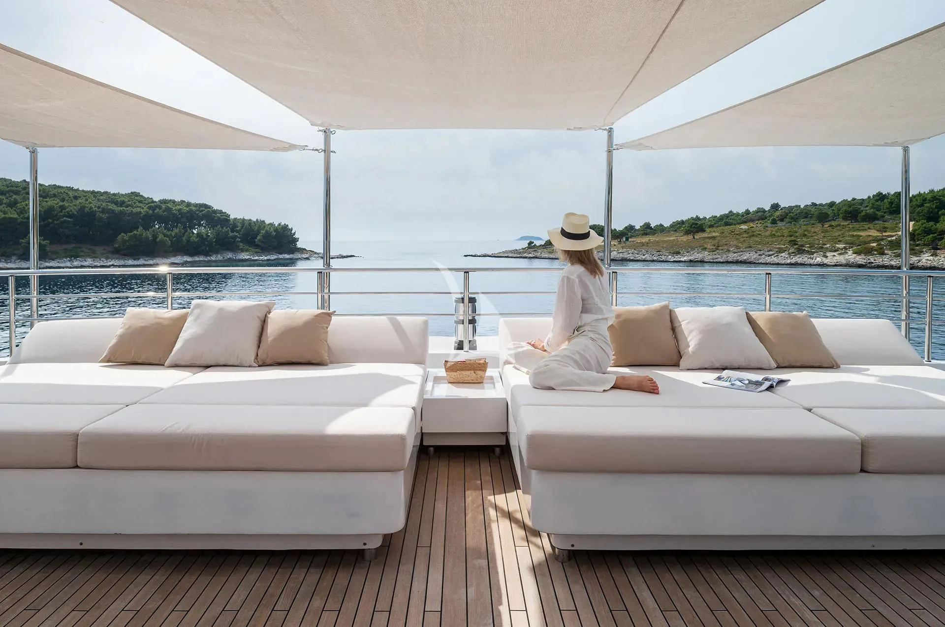 a person sitting on a couch aboard TALEYA Yacht for Sale