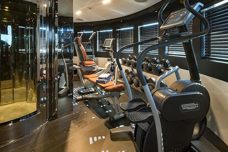 a room with many exercise equipment aboard TALEYA Yacht for Sale