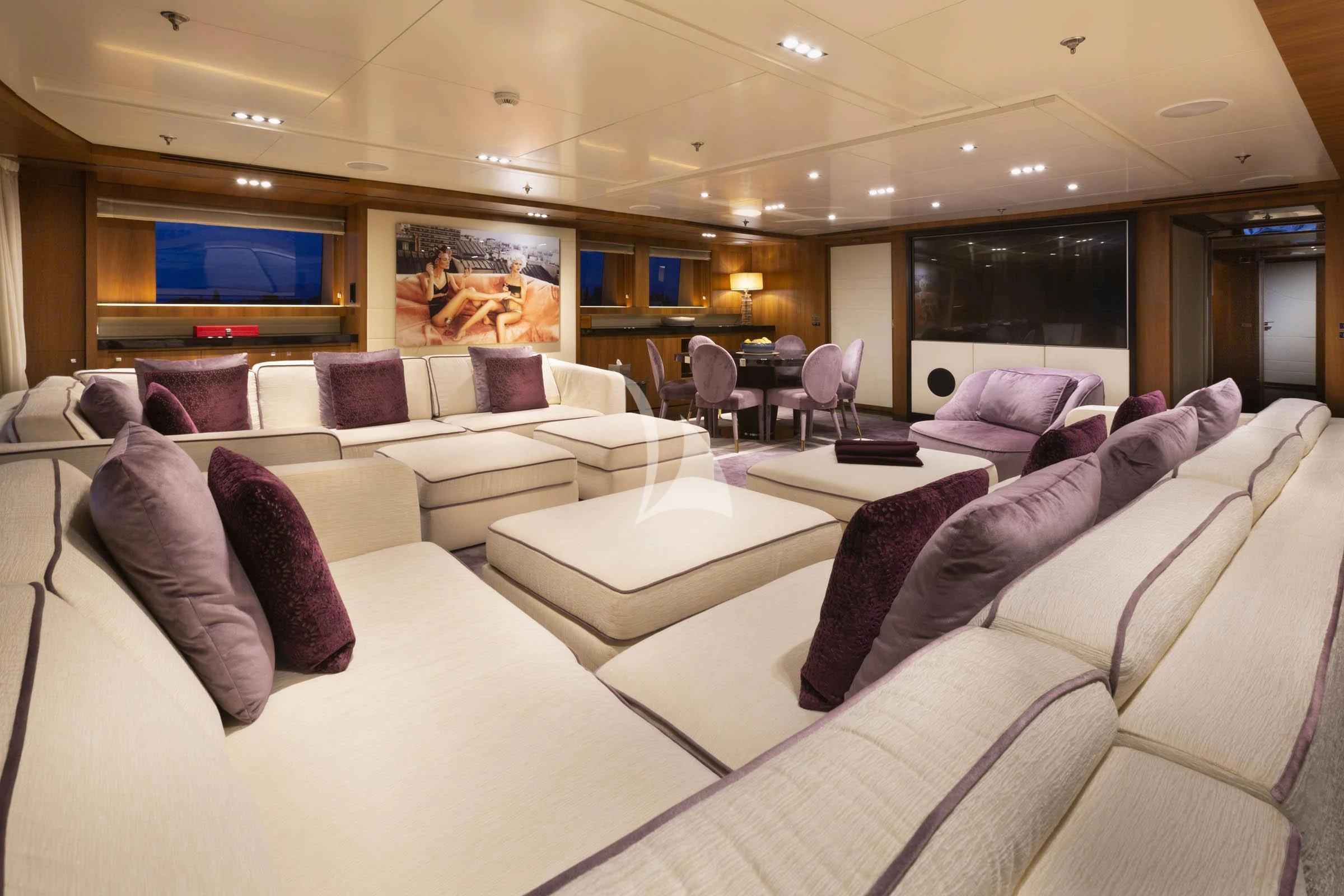 a large living room with a large screen aboard TALEYA Yacht for Sale