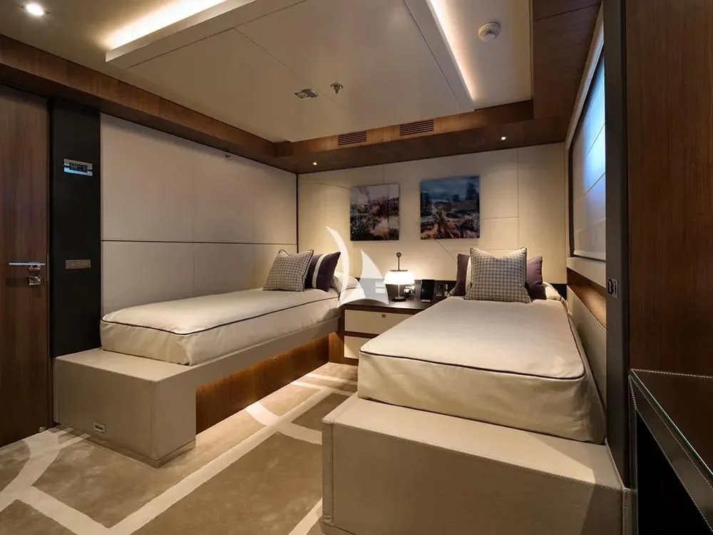 a room with a bed and a television aboard TALEYA Yacht for Sale