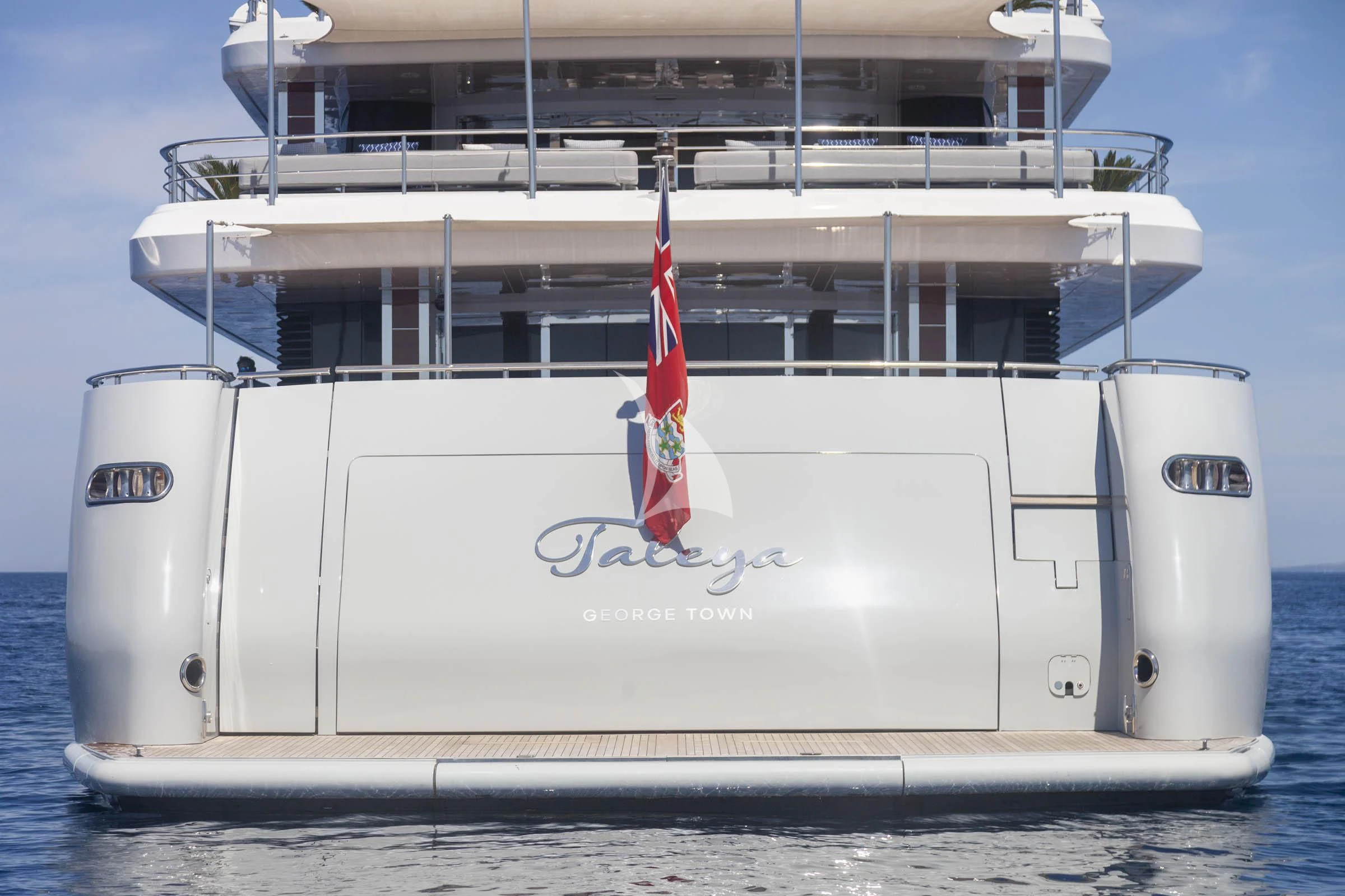 a large white boat with a flag on it aboard TALEYA Yacht for Sale