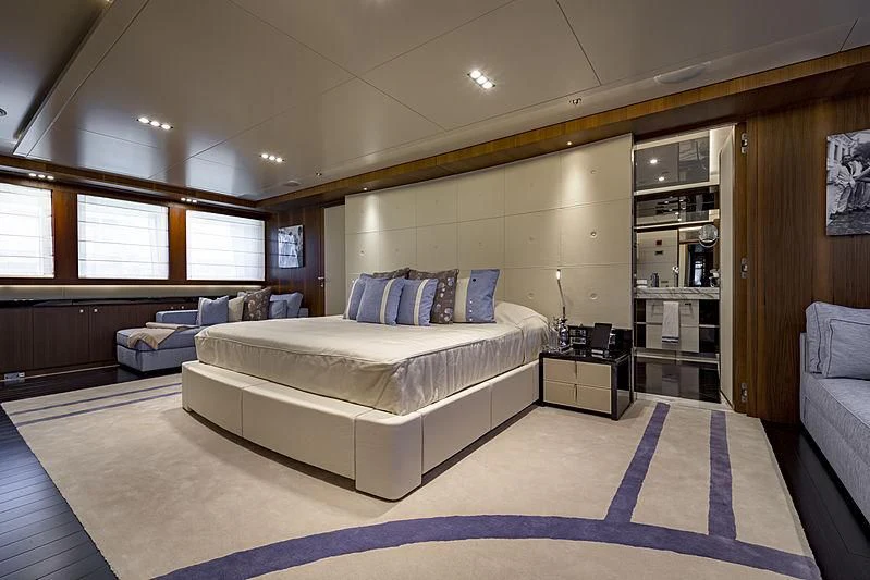 a large bedroom with a bed aboard TALEYA Yacht for Sale