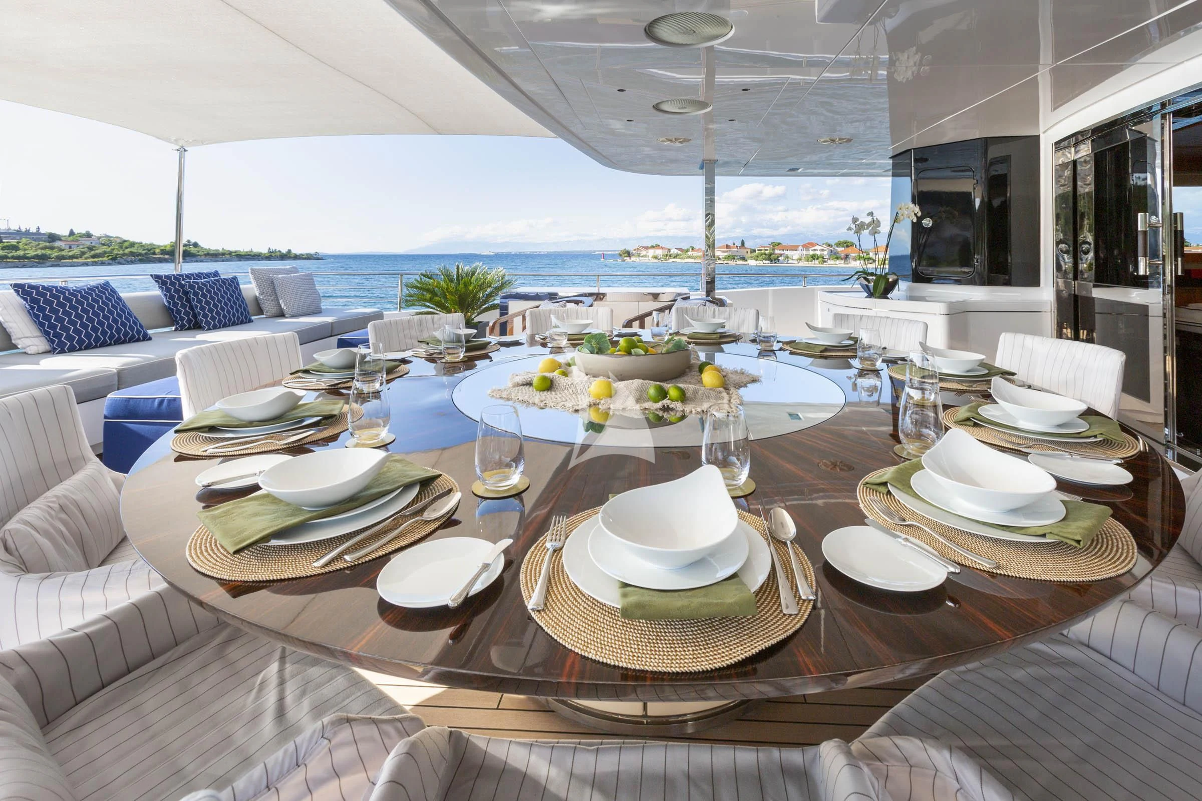 a table with plates and glasses on it aboard TALEYA Yacht for Sale