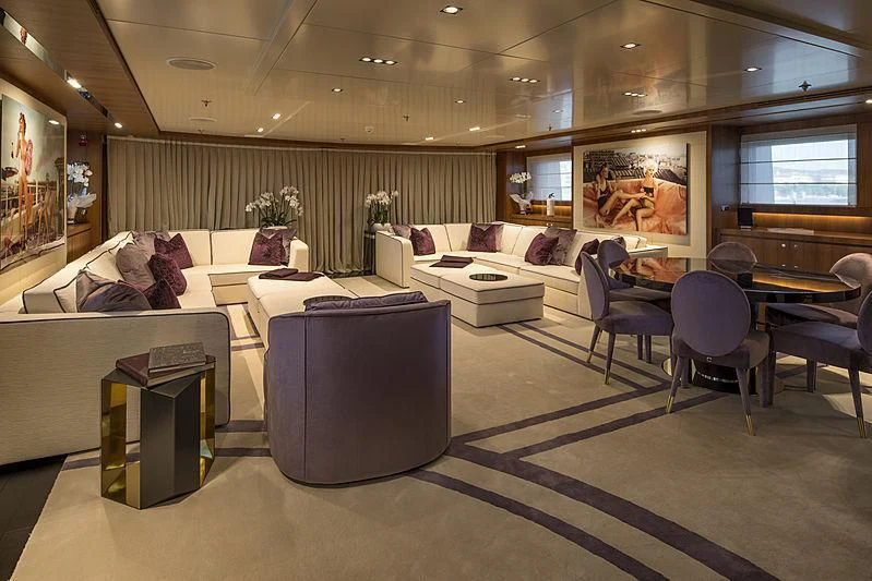 a large living room with a couch and a table aboard TALEYA Yacht for Sale