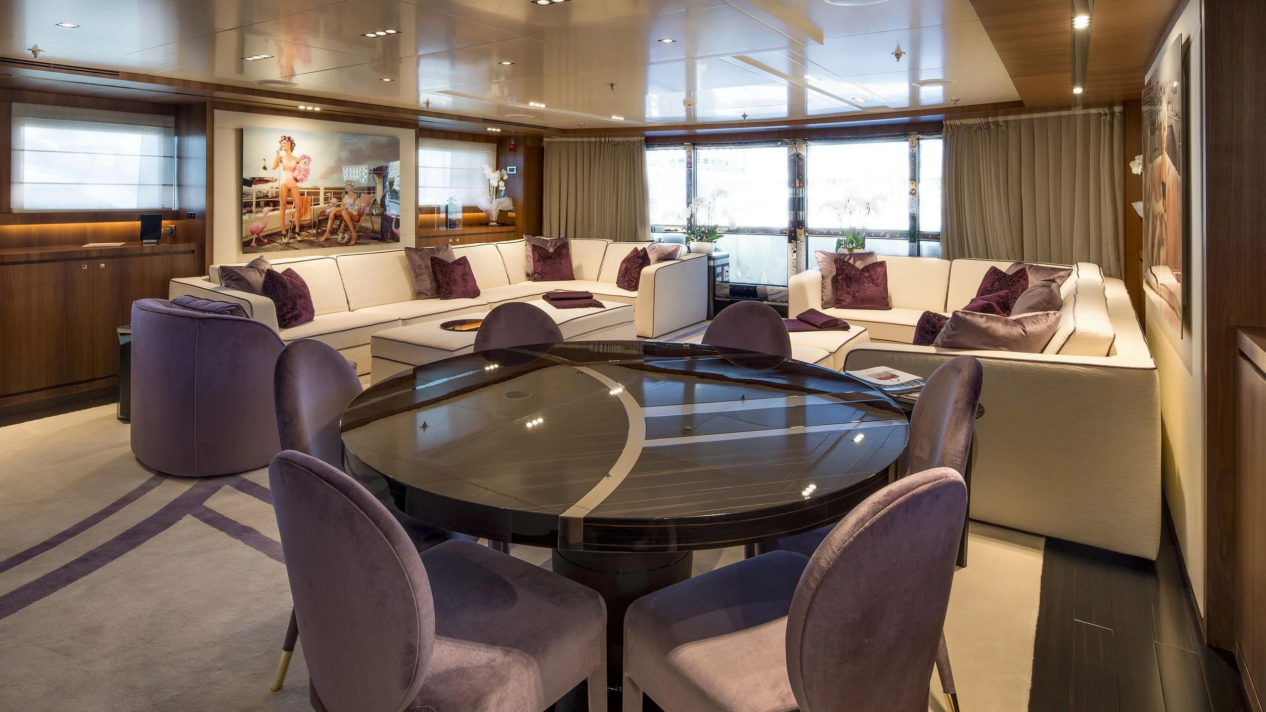 a large room with a table and chairs aboard TALEYA Yacht for Sale