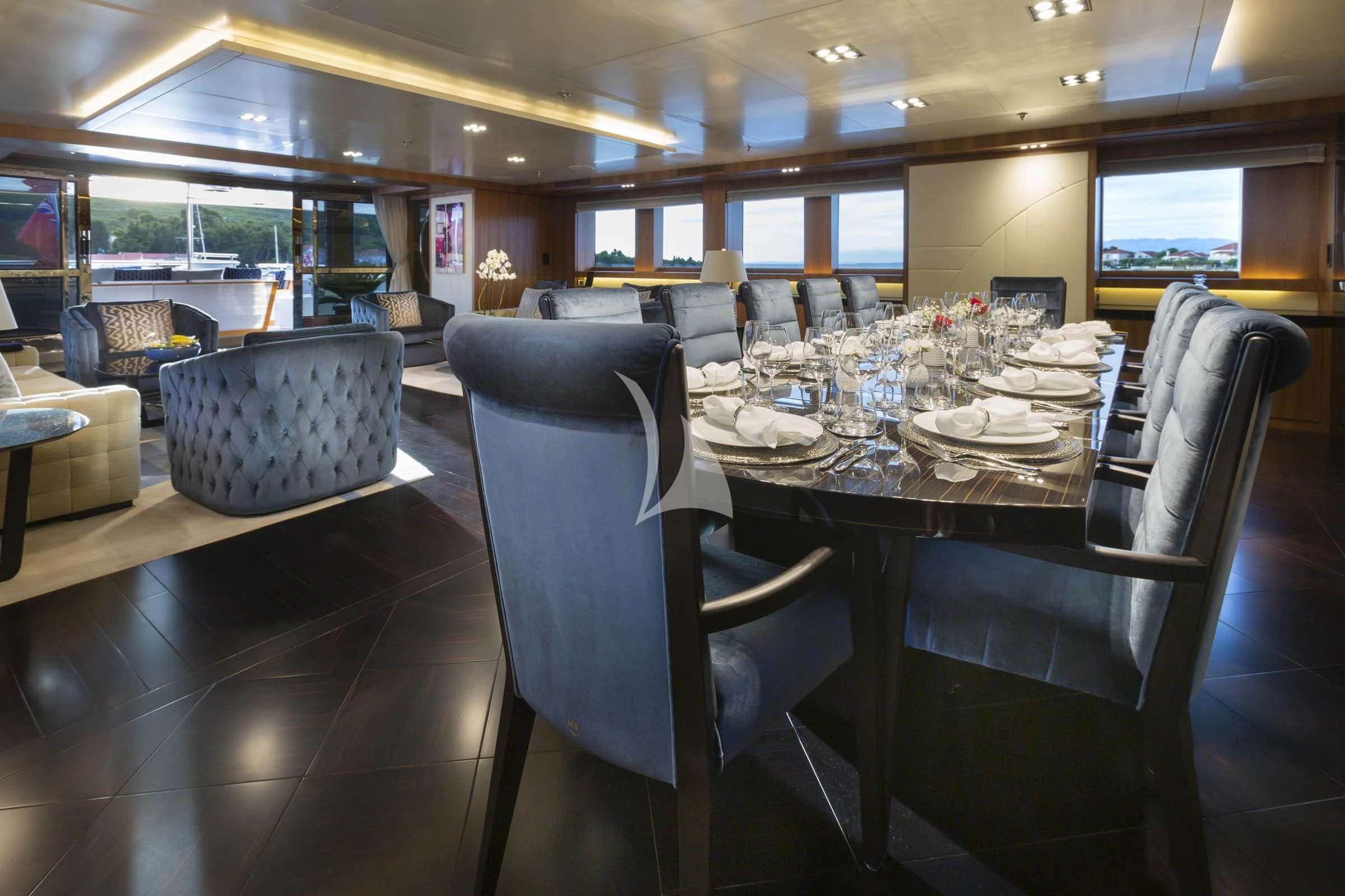 a dining room with a table and chairs aboard TALEYA Yacht for Sale