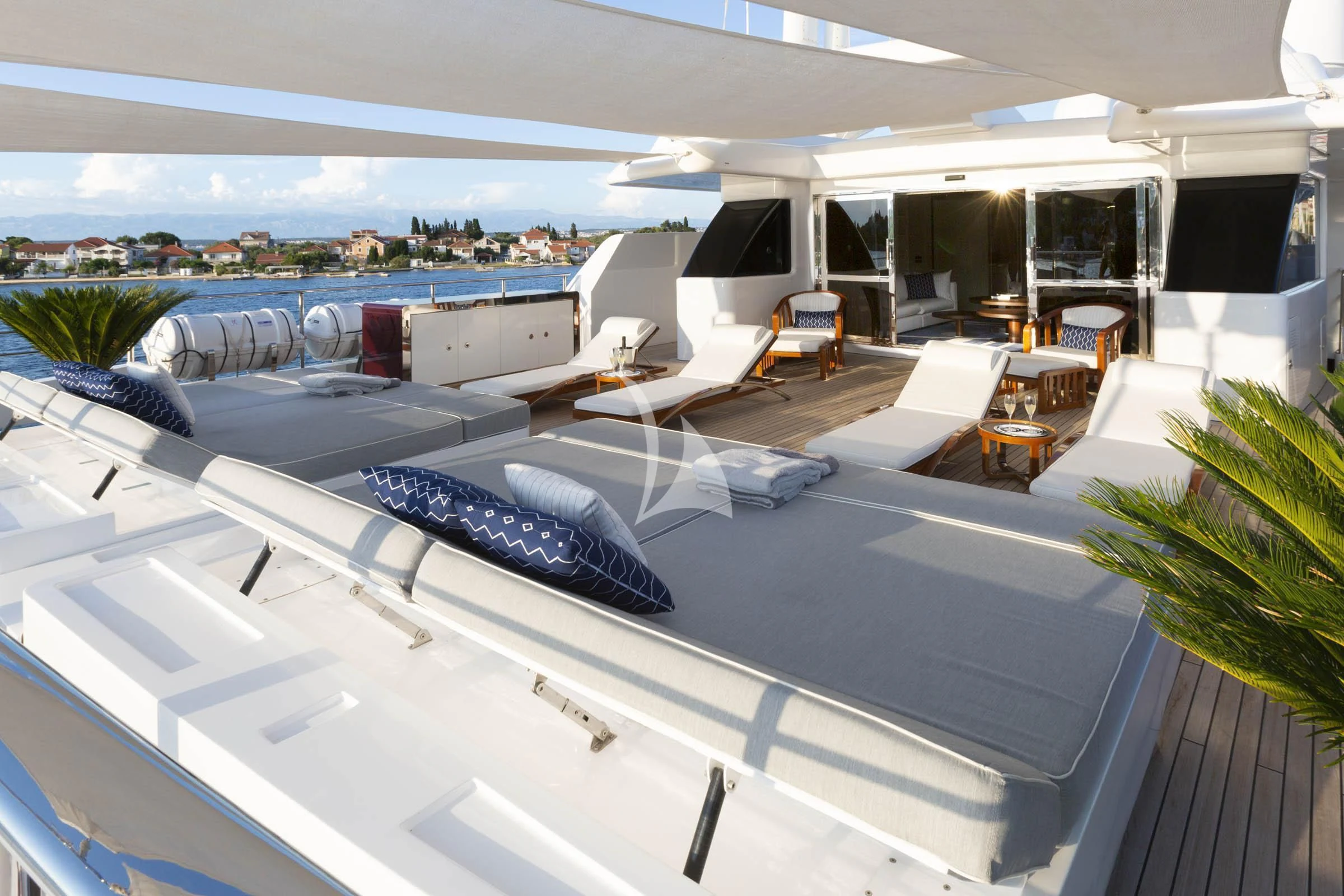 a large room with a pool table and chairs aboard TALEYA Yacht for Sale