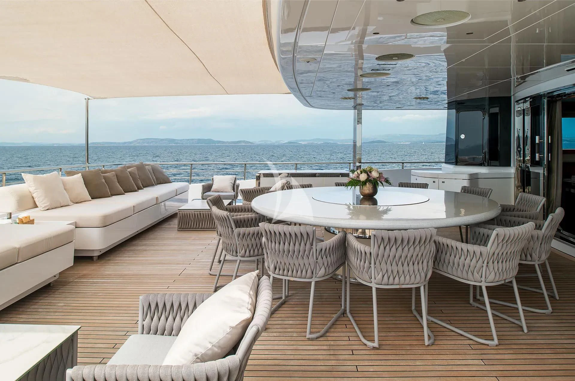a room with a table and chairs aboard TALEYA Yacht for Sale