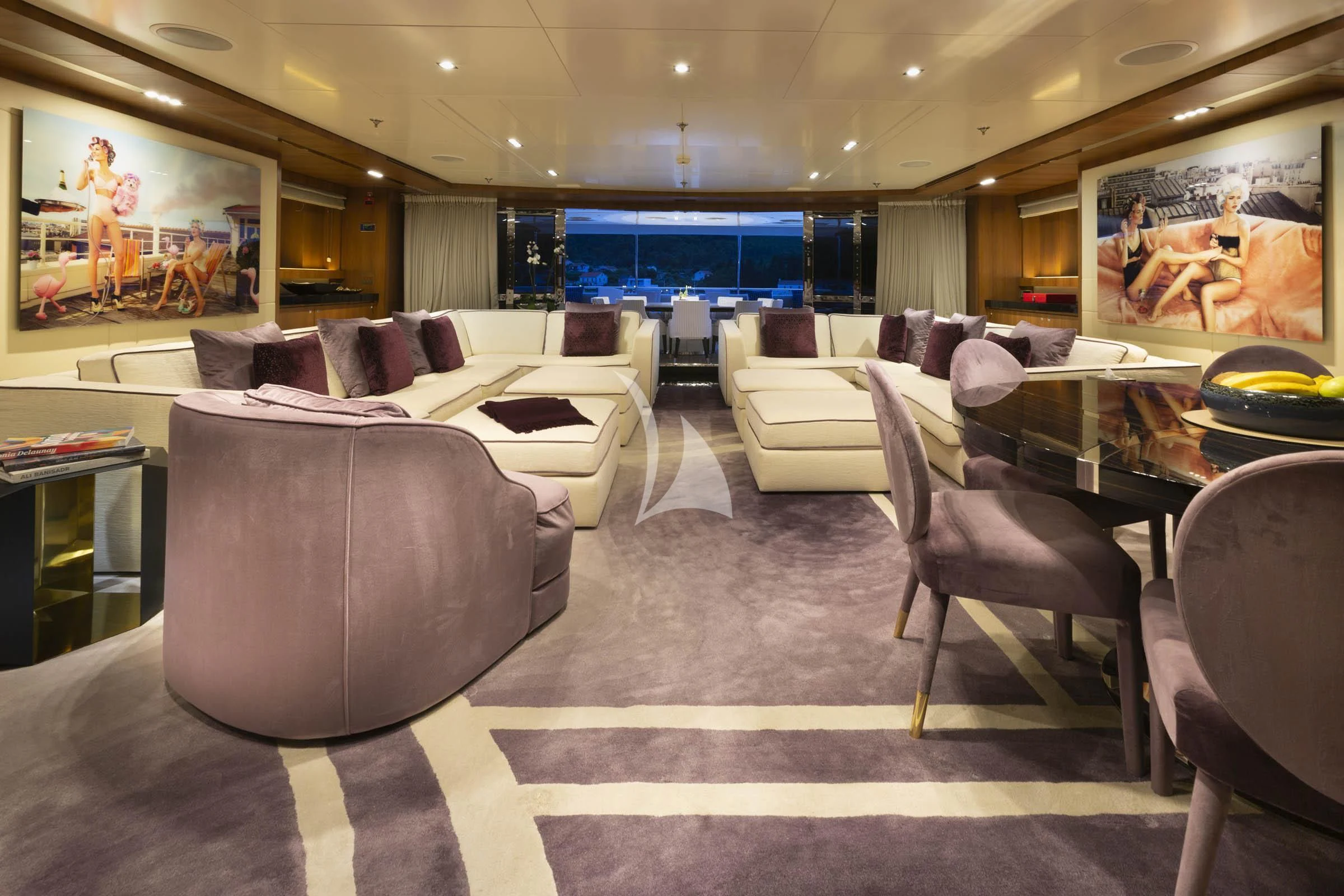 a large room with a couch and a tv aboard TALEYA Yacht for Sale