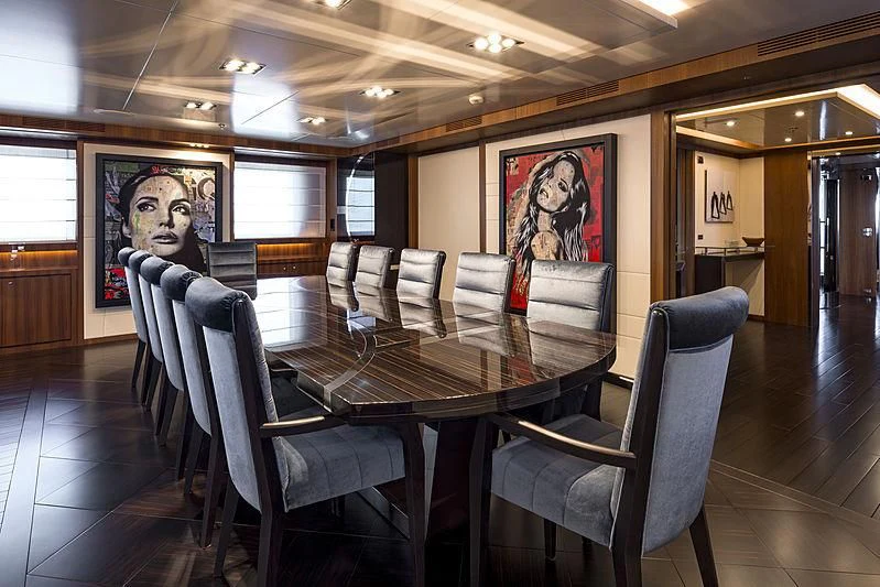 a room with a table and chairs aboard TALEYA Yacht for Sale
