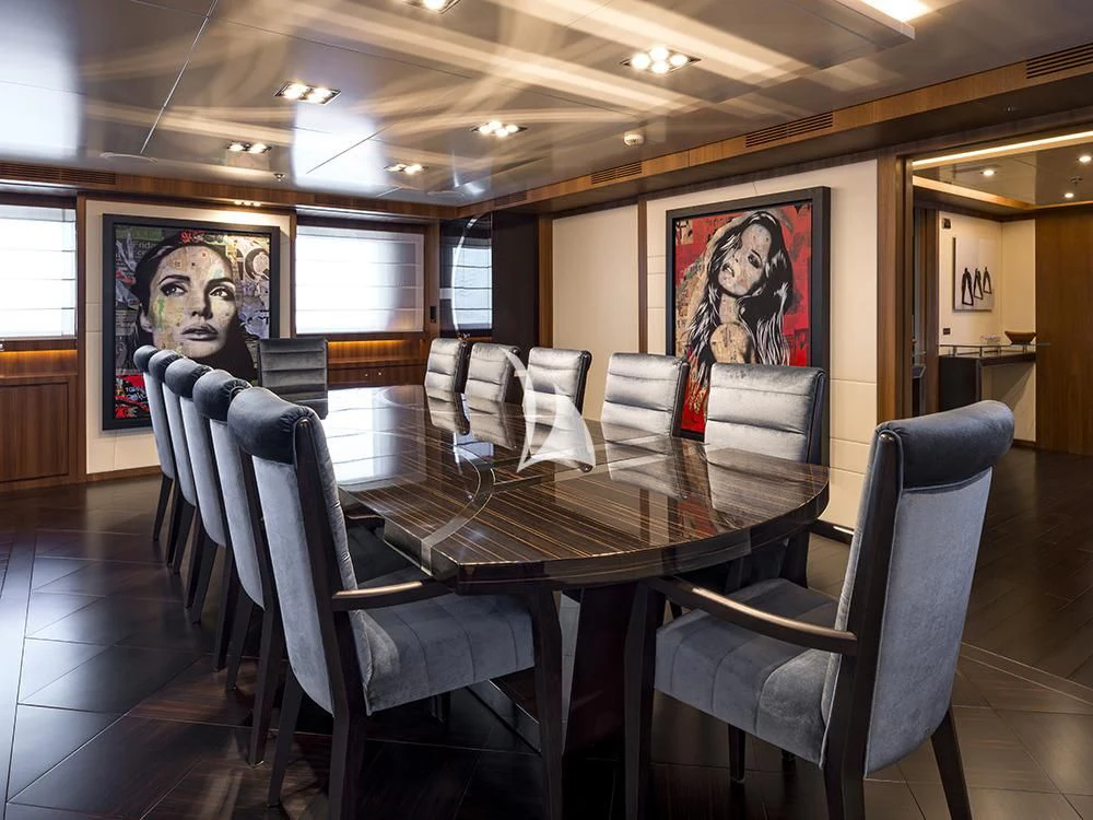 a room with a table and chairs aboard TALEYA Yacht for Sale