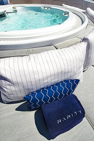 a white chair with a blue cushion aboard TALEYA Yacht for Sale
