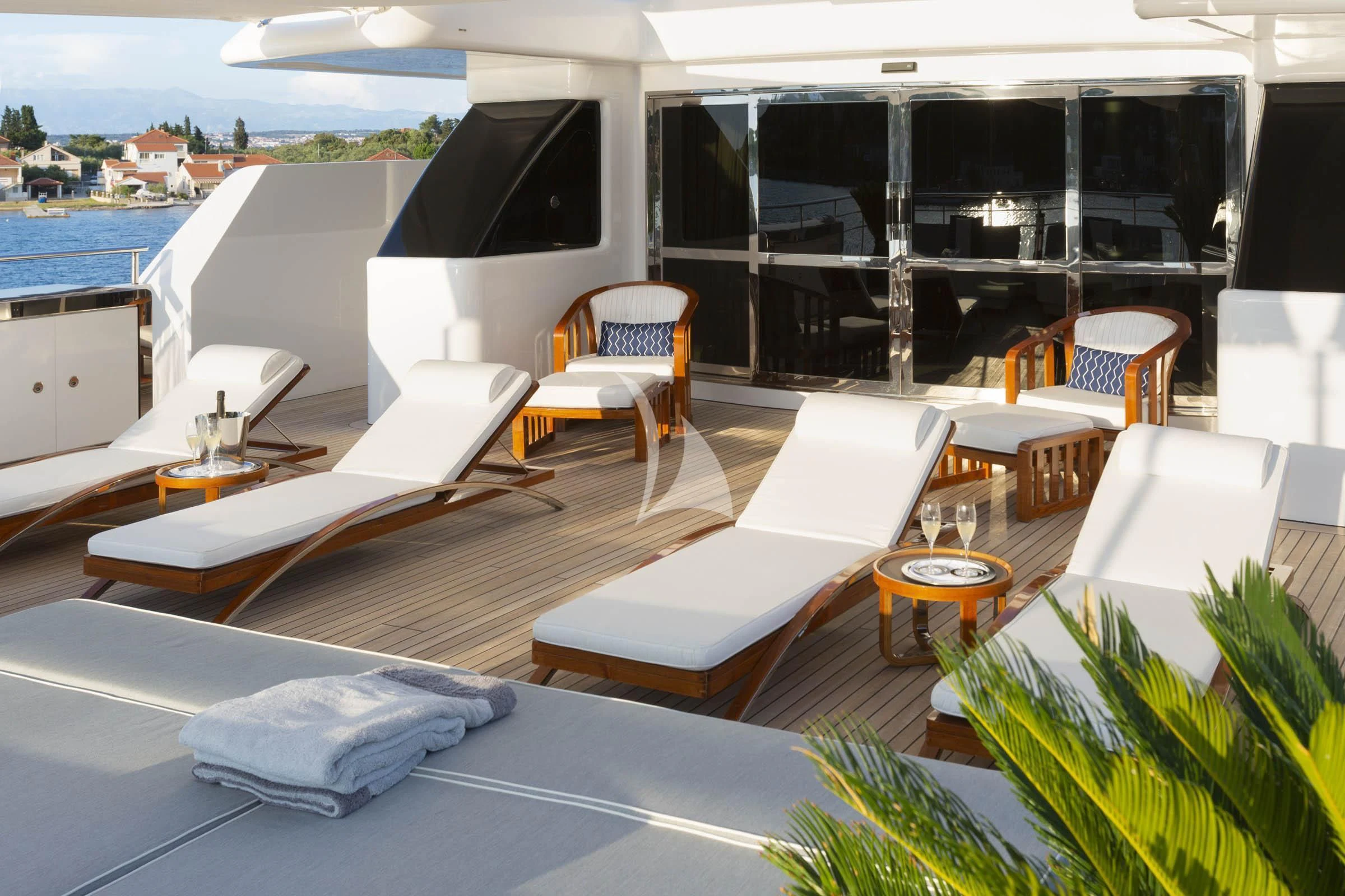 a room with lounge chairs and a tv on the wall aboard TALEYA Yacht for Sale