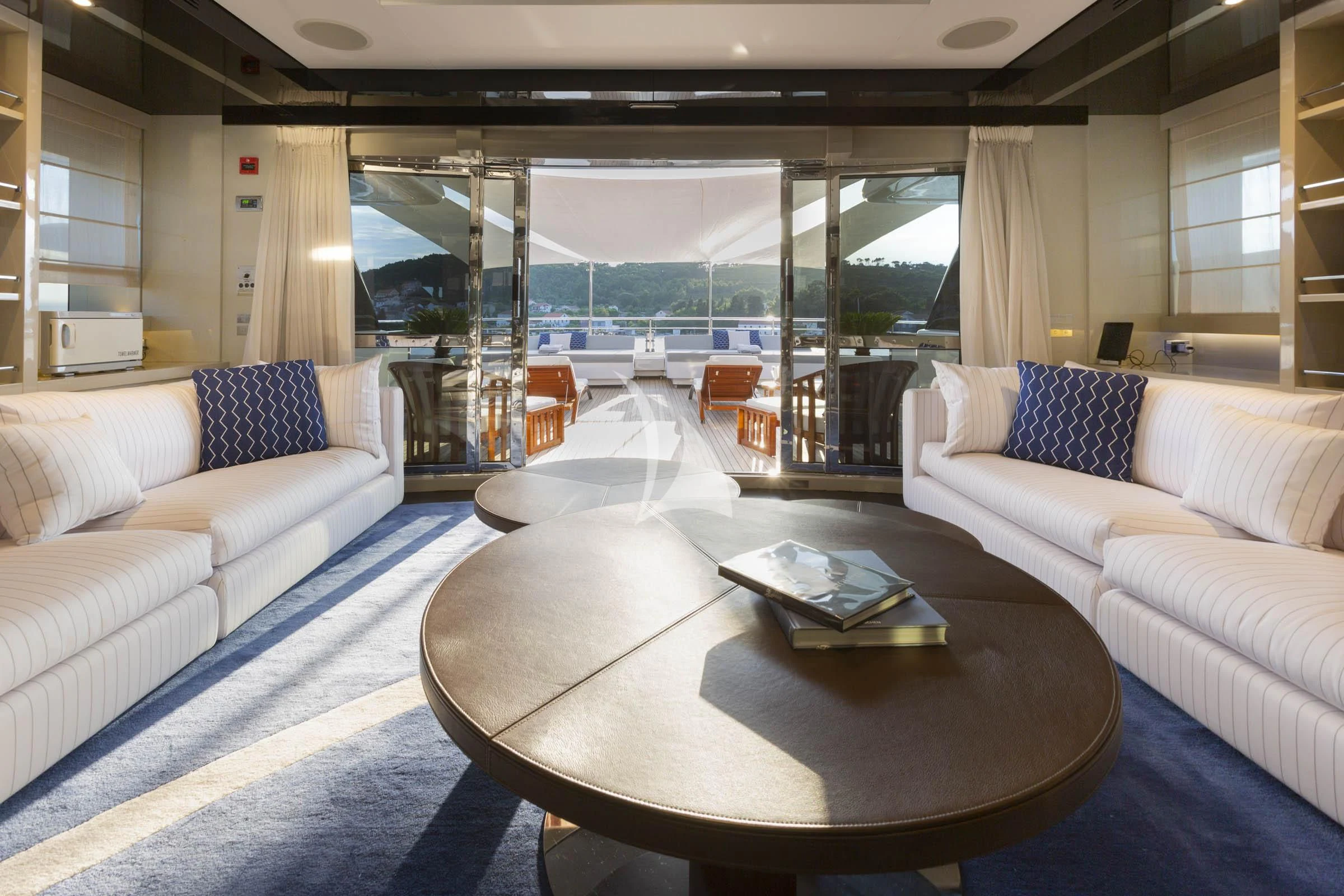 a living room with a large glass window aboard TALEYA Yacht for Sale