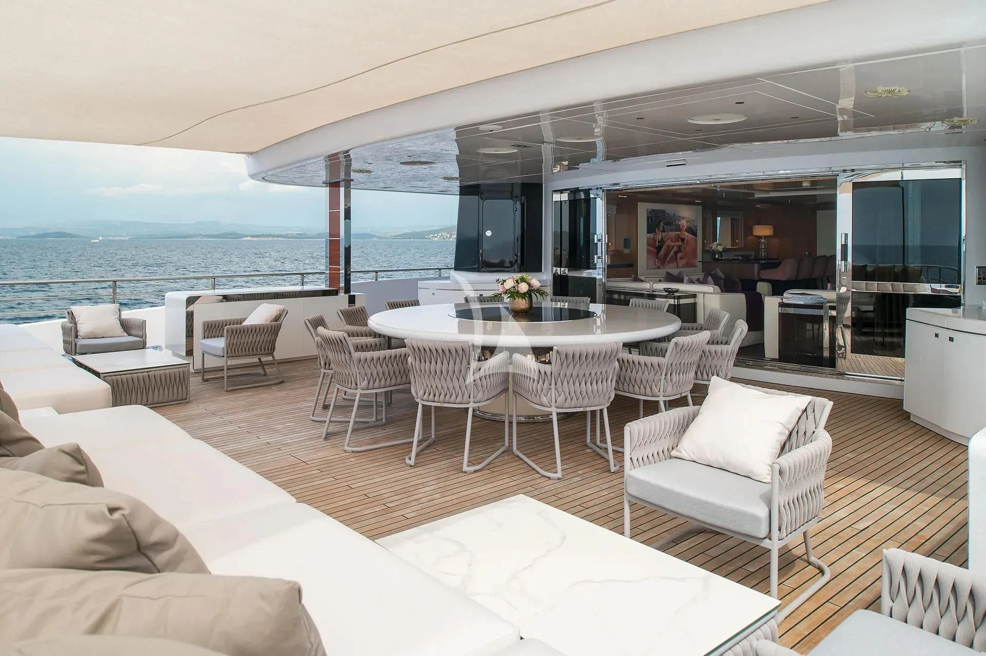 a room with a table chairs and a large window aboard TALEYA Yacht for Sale