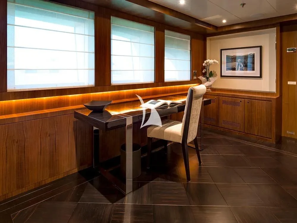 a room with a table and chairs aboard TALEYA Yacht for Sale