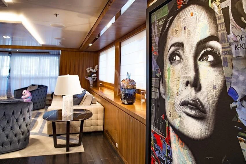 a room with a large painting on the wall aboard TALEYA Yacht for Sale