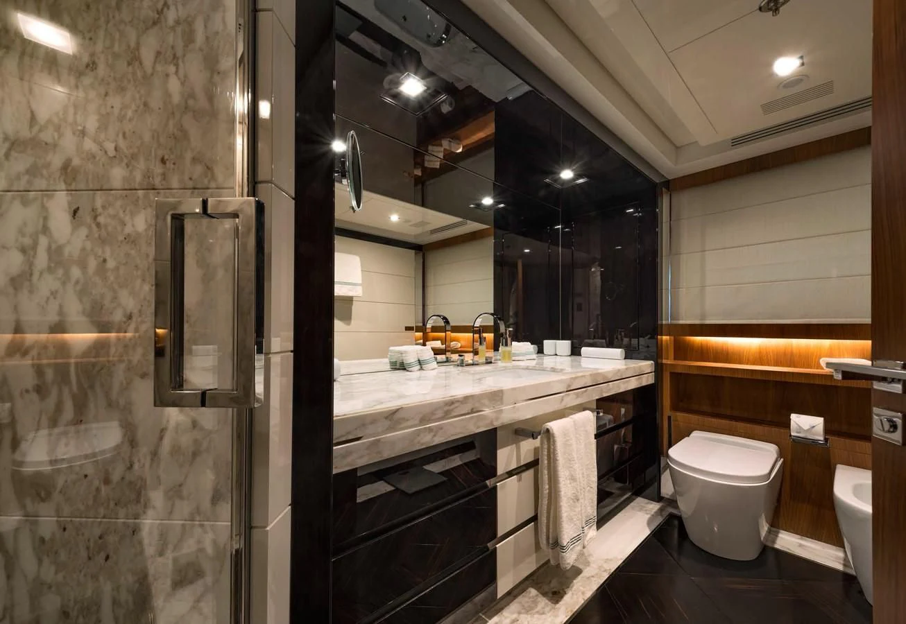 a bathroom with a large mirror aboard TALEYA Yacht for Sale