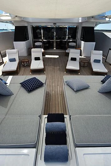 a room with a bed and desks aboard TALEYA Yacht for Sale