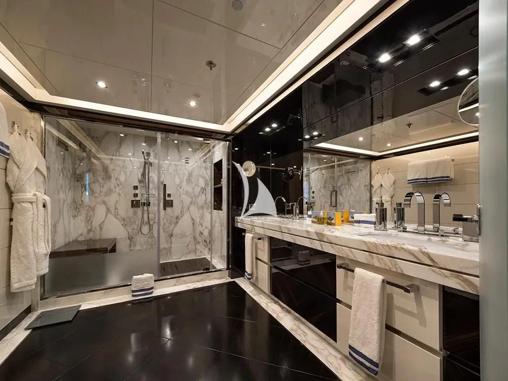 a bathroom with a countertop sink and a mirror aboard TALEYA Yacht for Sale