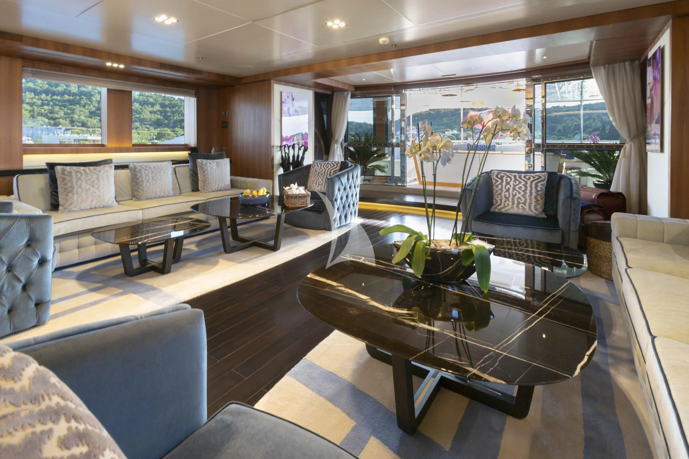 a living room with a table and chairs aboard TALEYA Yacht for Sale