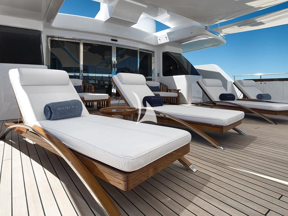 a room with a deck chairs and a large window aboard TALEYA Yacht for Sale