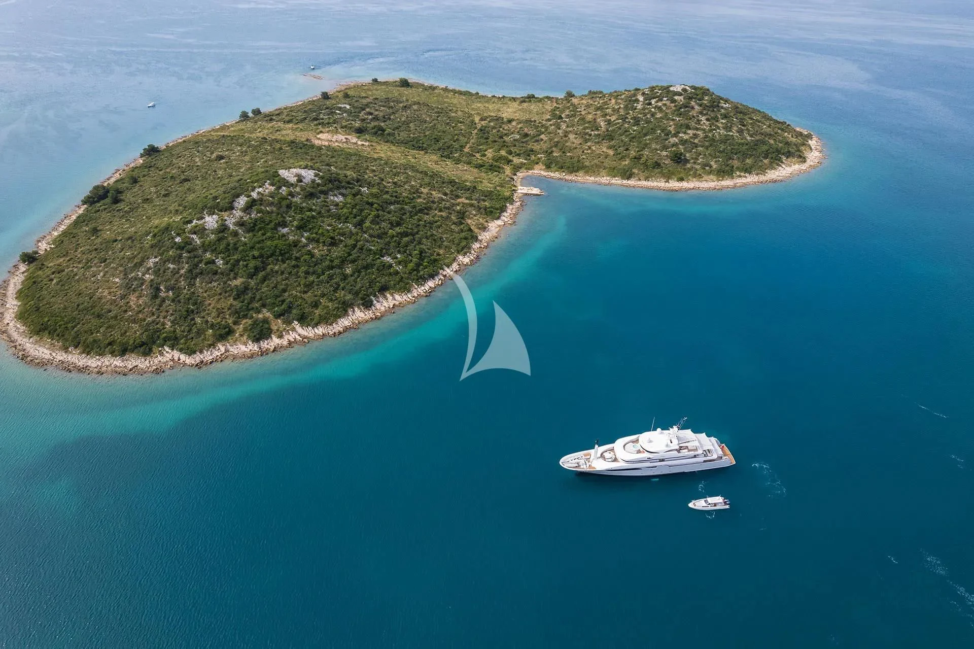 a small island with a boat aboard TALEYA Yacht for Sale
