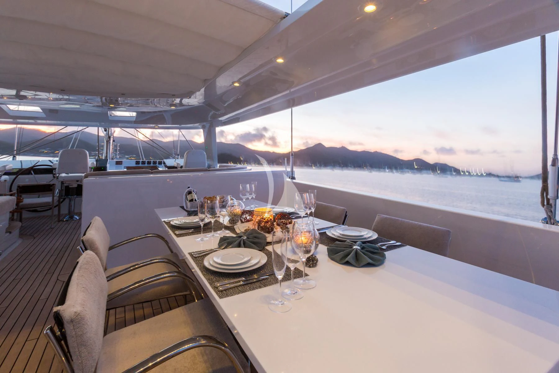 a table with plates and glasses on it aboard SPIRIT OF THE C'S Yacht for Charter