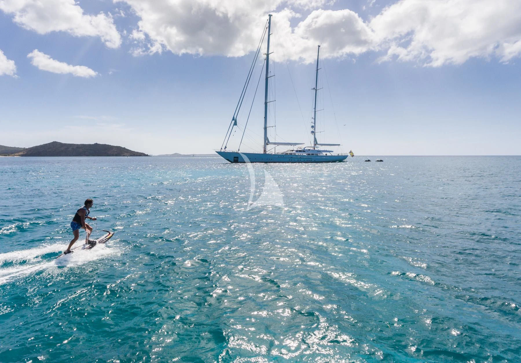 a person surfing in the sea aboard SPIRIT OF THE C'S Yacht for Charter