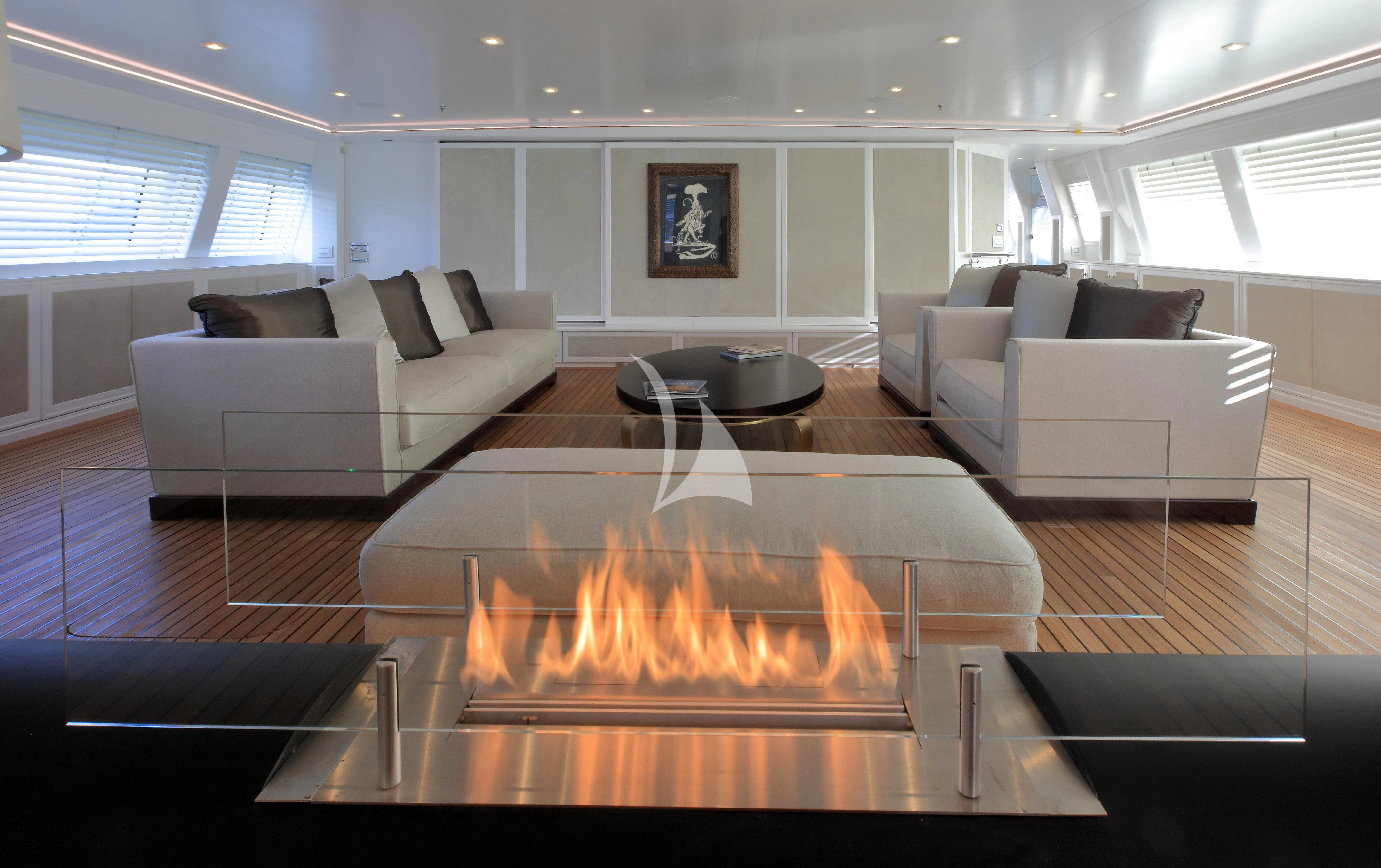 a living room with a fireplace aboard SPIRIT OF THE C'S Yacht for Charter