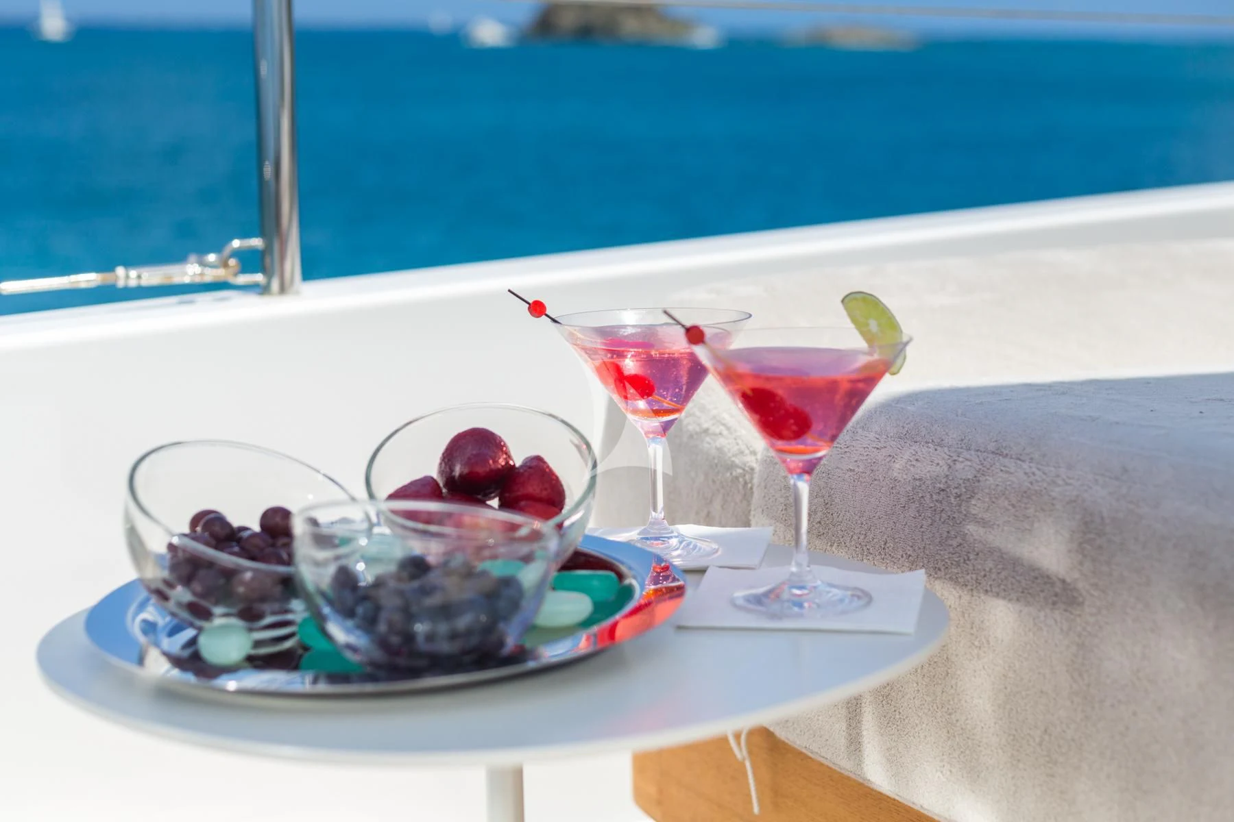 a plate of food and glasses of wine on a table aboard SPIRIT OF THE C'S Yacht for Charter
