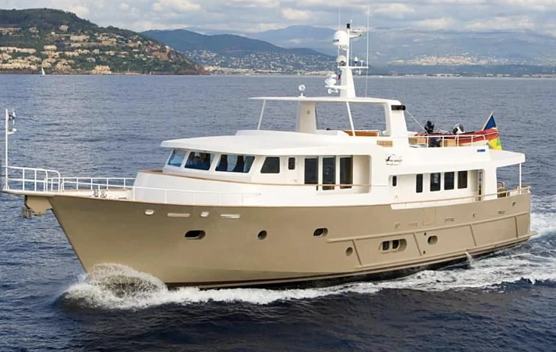 a white boat on the water aboard AKISSI Yacht for Sale